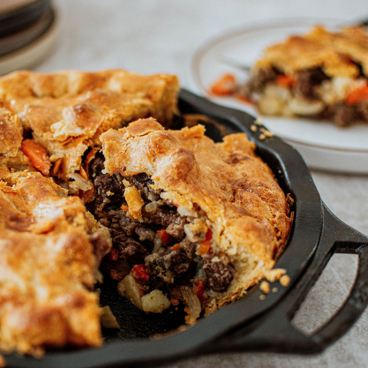 hearty meat pie in a cast iron pie pan