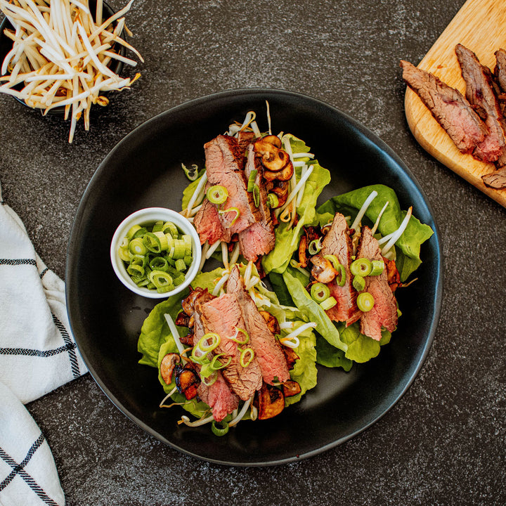 flank steak lettuce cups on a plate